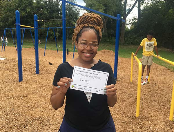 Girl holding certificate for Akron Parks Challenge