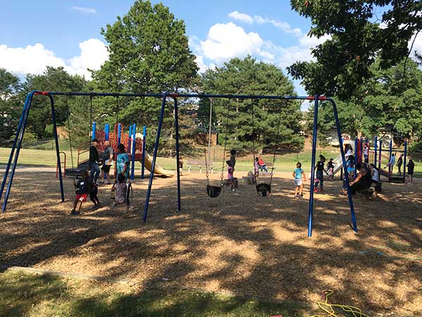 kids playing on swings in playground