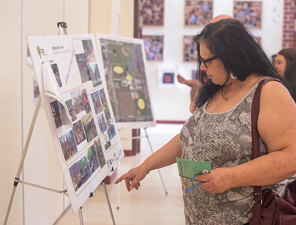 Community engagement - lady pointing at photos