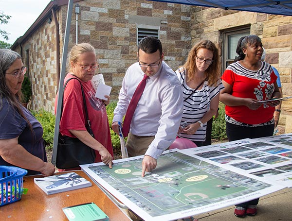 Community engagement - people looking at maps